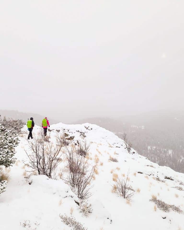 2 girls walking in the snow to a viewpoint is a a great winter hike for this explorer.