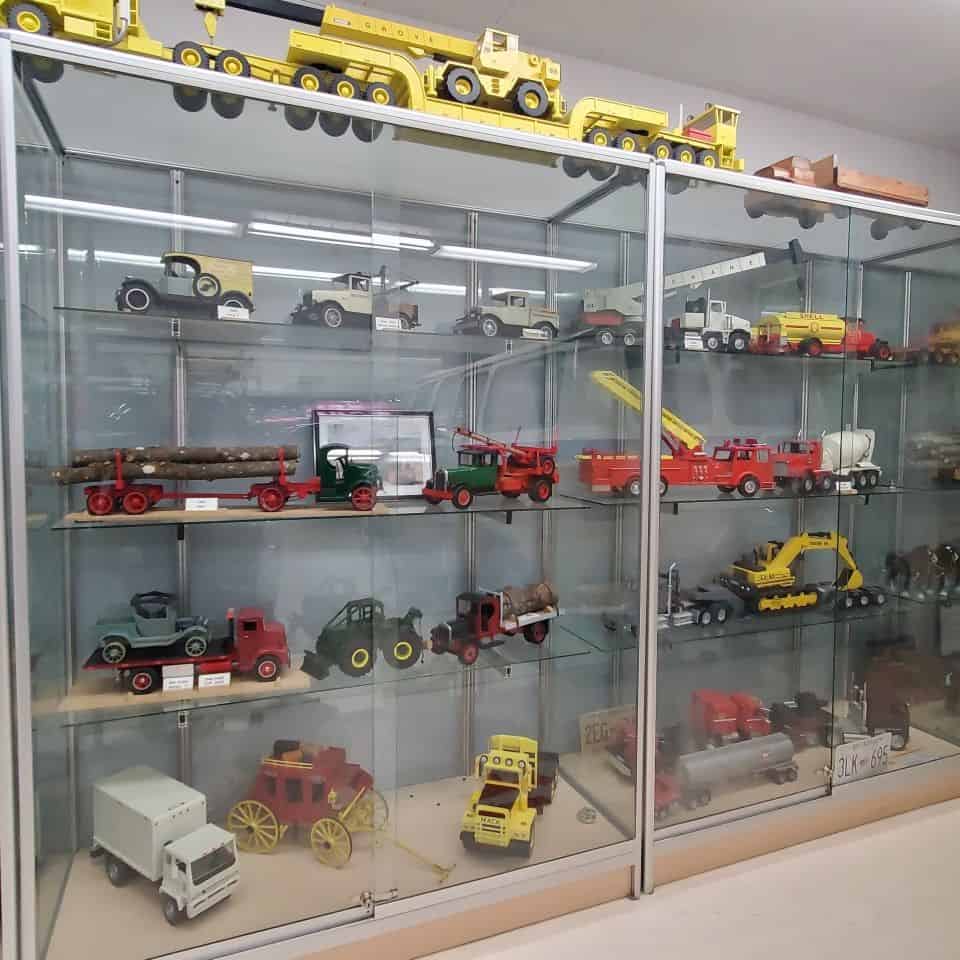 Vintage vehicles and trucks are nicely displayed on well-lit shelves at this Surrey BC attraction in Canada.