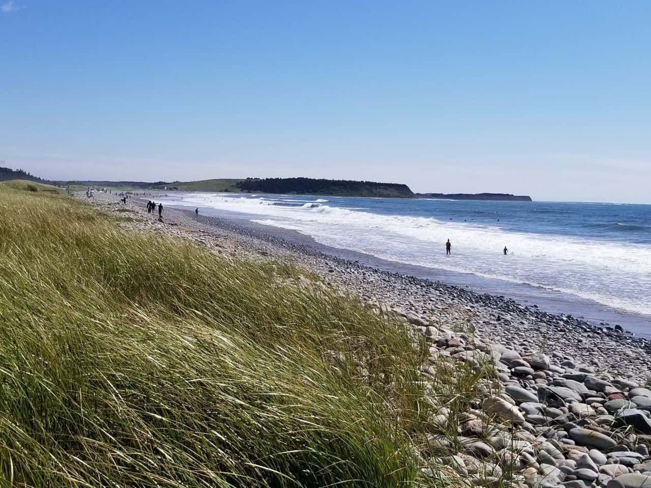 Surfers flock to Lawrencetown Beach along the Atlantic View Trail, NS to catch the perfect wave