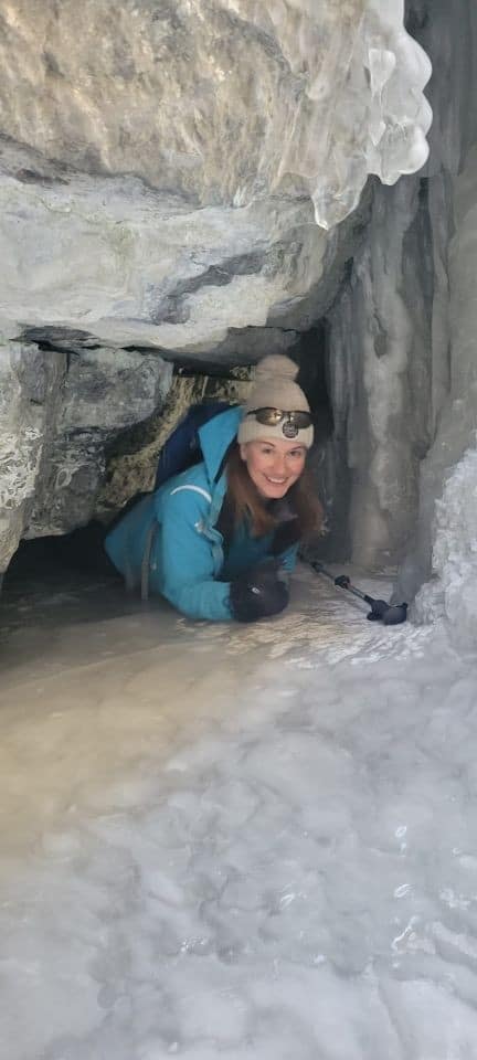 It is a tight squeeze fitting through an opening in the ice cave on the Maligne Canyon Icewalk.