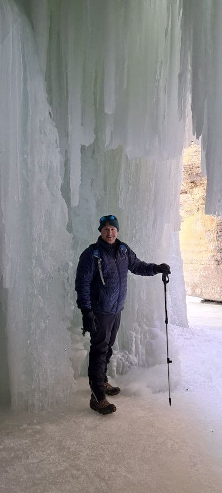 Standing inside the ice cave behind a frozen waterfall in Maligne Canyon.