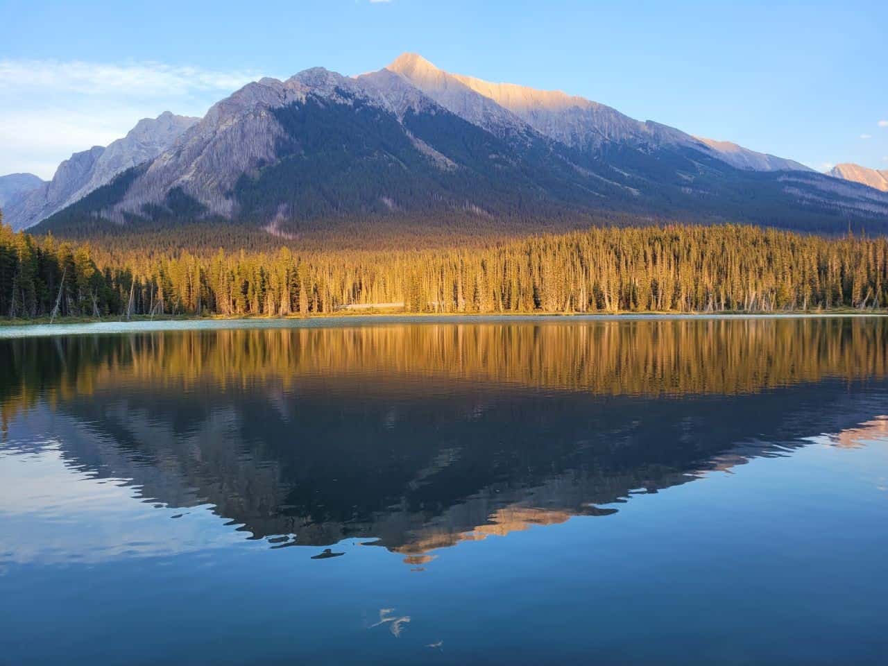 The High Rockies Trail in Alberta offers stunning mountain scenery, perfect reflections, and gorgeous sunsets along its length.