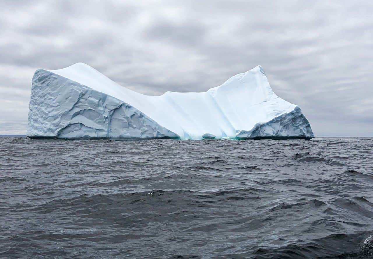 Iceberg icebergs NL Newfoundland Labrador ice icy berg season bergs clouds waves sea ocean