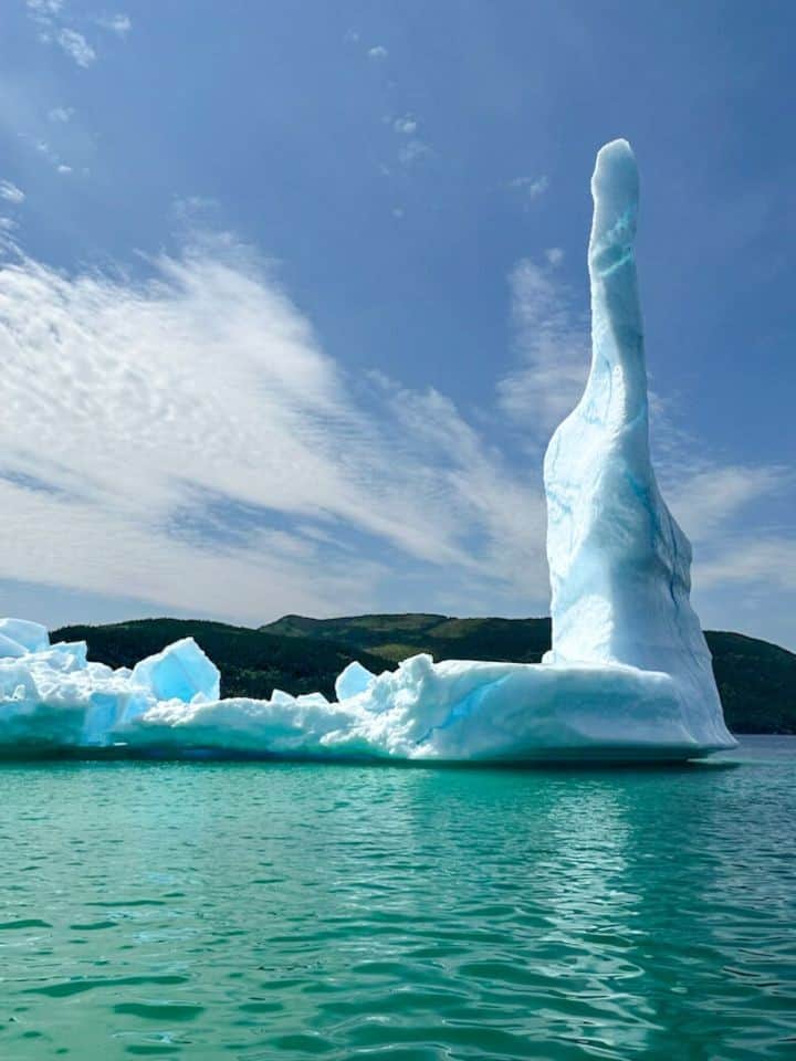Tall iceberg in Newfoundland making its way down the eastern coastline of Canada in July near Torbay Newfoundland Canada.
