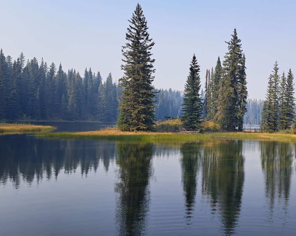 This peaceful lake can only be reached by the Emerson Lake Trail in Sundance Provincial Park Alberta Canada.