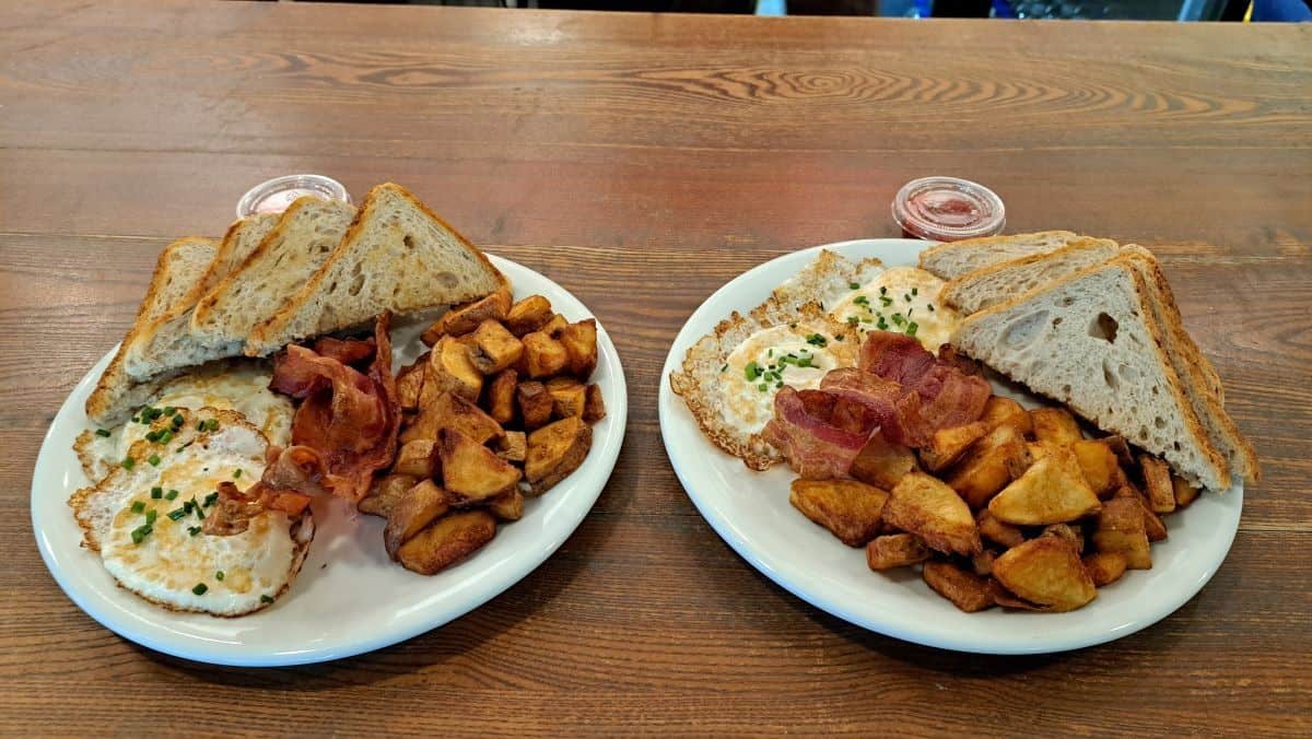 Over easy eggs, toast, bacon and freshly made has browns make a hearty breakfast at Miss Browns in the Hargrave St Market in Winnipeg Manitoba Canada