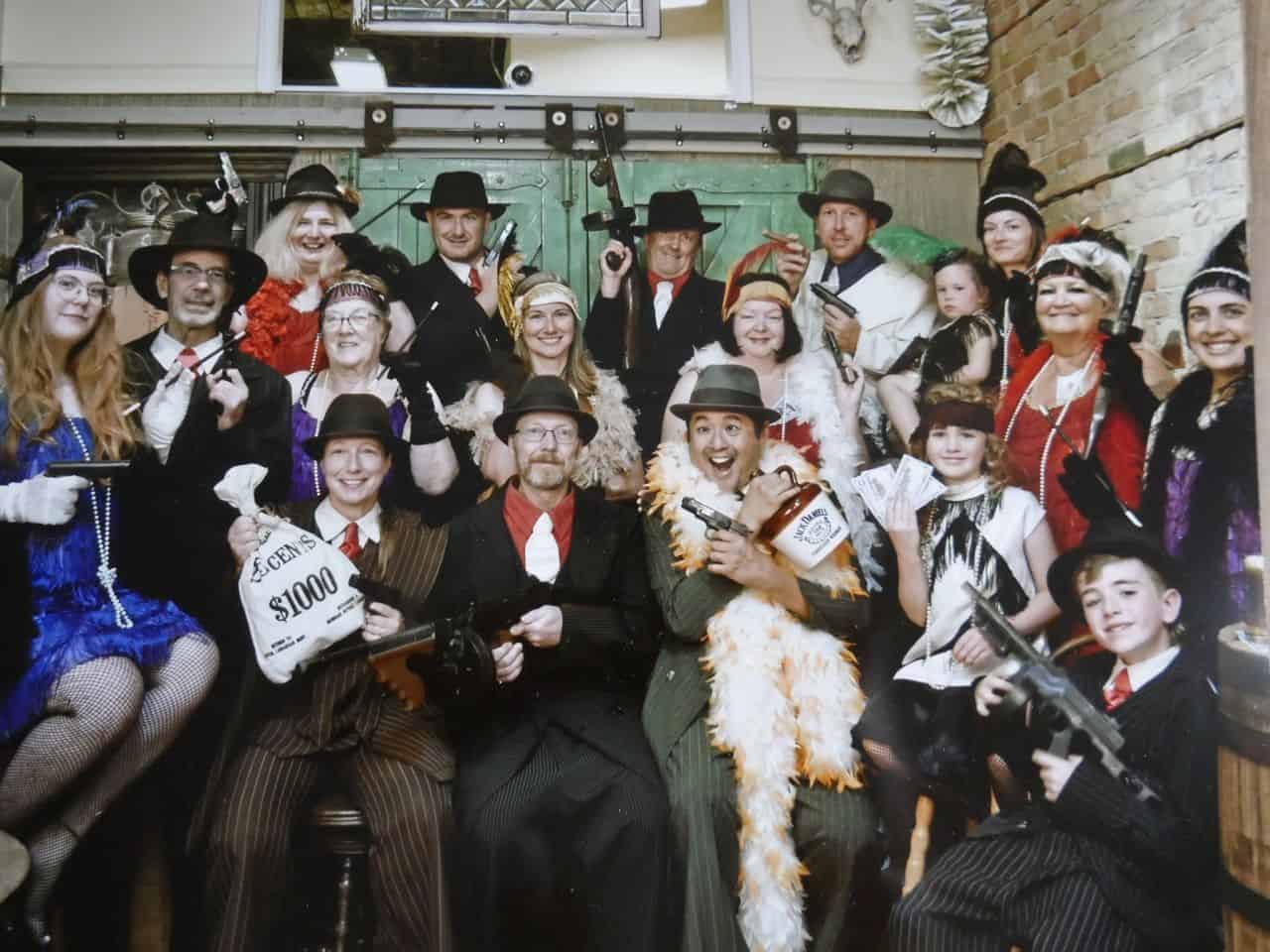 The Canada Adventure Seekers dress up as gangsters at Past Times Photography in Moose Jaw.