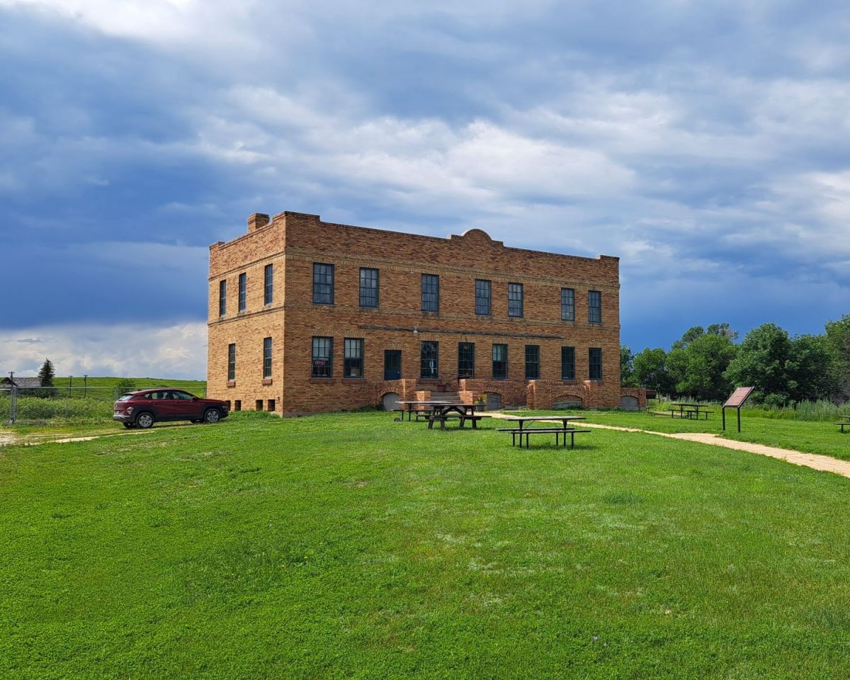 A 2 storey historic bunkhouse made of brick at the Claybank Brick Plant National Historic Site. Once home to workers at the plant, the Bunkhouse is now houses the interpretive centre and cafe.