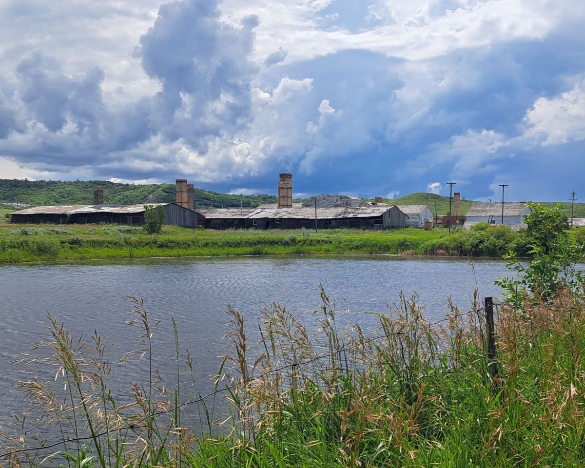 Claybank Brick Plant National Historic Site as seen from across a pond.