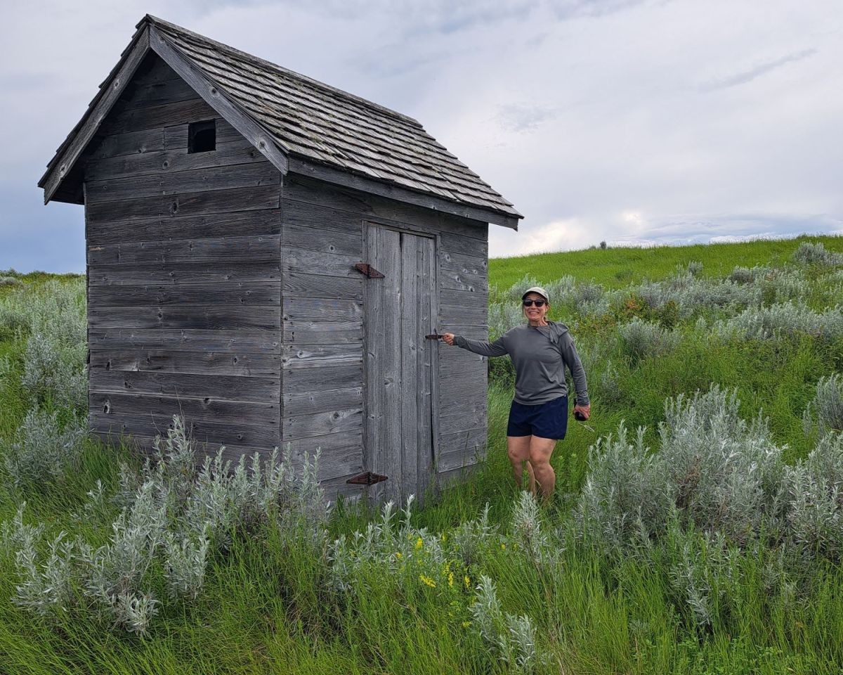 Canada Adventure Seeker Lisa Muldoon tries to open a door to a historic wooden shack at the Claybank Historic Site. Is she hoping it is an outhouse? It is not, poor girl.