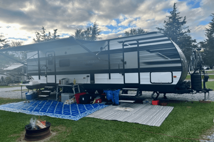 Camping trailer set up for a weekend of camping including tables, chairs and bikes at 1000 Islands KOA, Kingston, Ontario