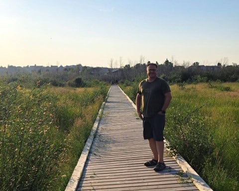 Walking along the boardwalk in the Rotary Centennial Waterfront Park in Yellowknife as dusk approaches.