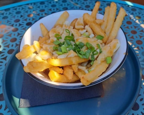 Woodshed Brewhouse is the restuarant attached to NWT Brewing Co. Traditional Canadian Poutine is on the menu. Poutine is made from french fires covered in squeaky cheese and gravy.