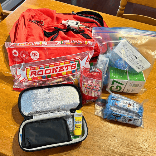 Diabetes supplies from a travel bag: continuous glucose monitoring devices, pump site supplies, snacks, rockets, emergency glucose