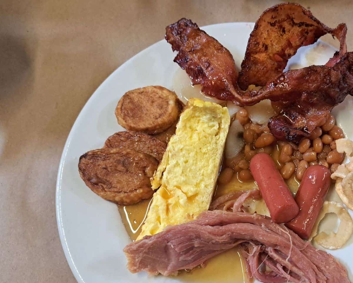 A traditional French Canadian sugar shack brunch includes bacon, baked brown beans, sausages, baked ham, eggs and potatoes. Everything is either made with or lathered in maple syrup.