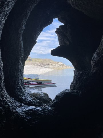 A view of our kayaks from a limestone cave on the Port au Port Peninsula, NL