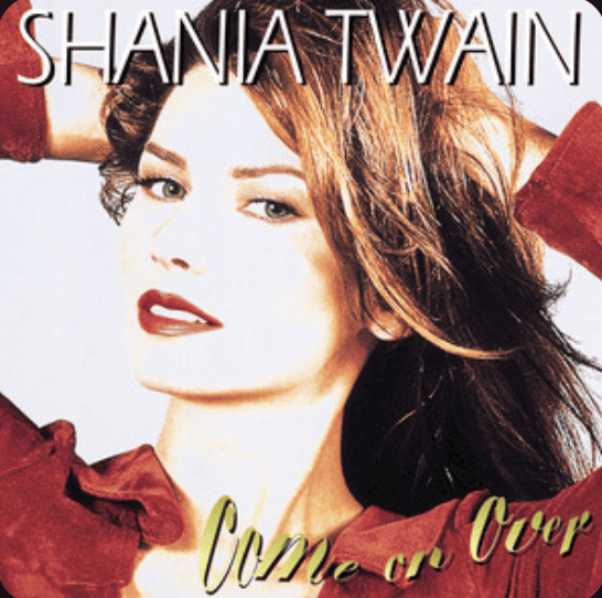 Shania Twain with her hands on her head looking at the camera, Come on Over album cover