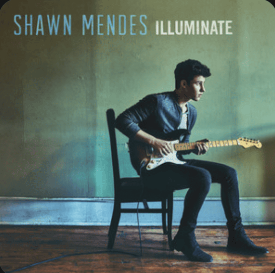 A young man sits on a chair in an empty room playing the guitar, Shawn Mendes Illuminate album cover
