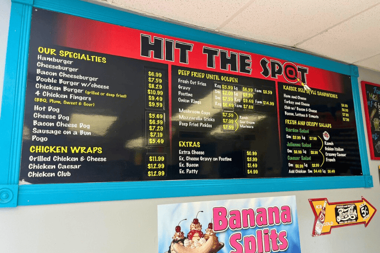 Red and black Hit the Spot menu as posted on the wall inside the restaurant.
