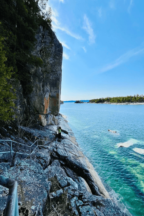 Rocky cliff, crystal clear blue water at Agawa Rock pictographs, Lake Superior.