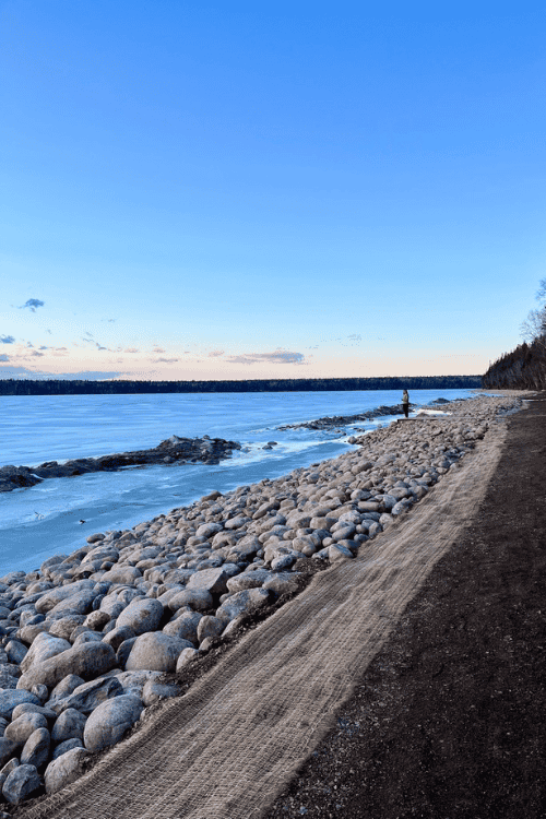 Shoreline covered with large boulders stretches on for miles at Riding Mountain National Park, Clear Lake.