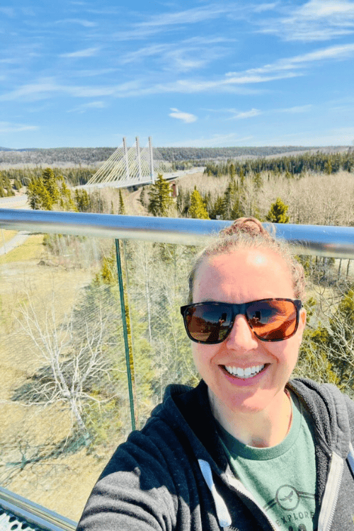 A woman smiles from the top of the Nipigon scenic-look-out over the Nipigon Bridge, Ontario