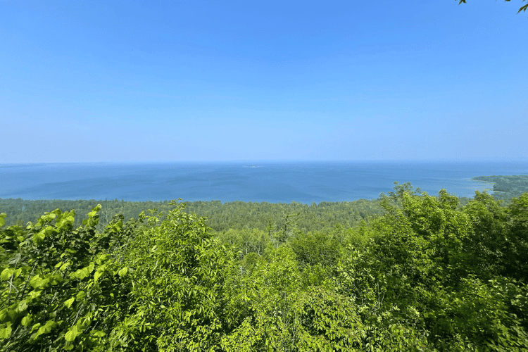 Panoramic view of blue water and green forest taken from Ten Mile Point on Manitoulin Island, Ontario.