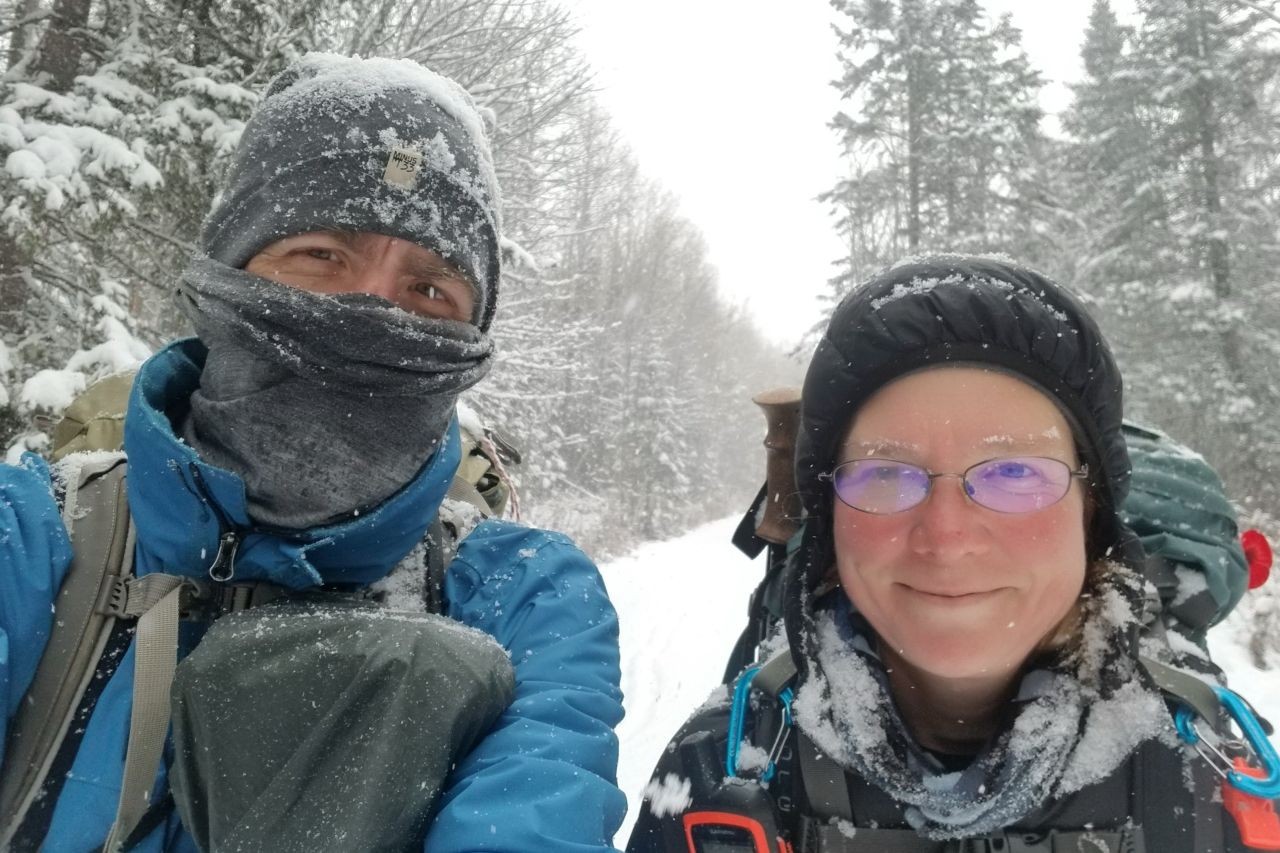 Both of us bundled up in warm layers while trekking through a snowstorm on the Trans Canada Trail. Proper insulation and waterproof layers are essential for winter hiking in Canada’s rugged terrain.