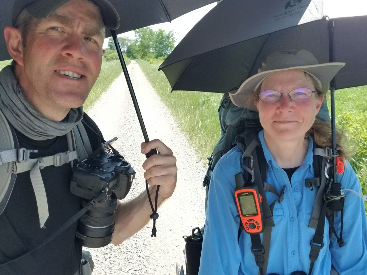 Sean and Sonya use Gossamer Gear sun umbrellas for much-needed shade on the Trans Canada Trail, proving that even lightweight gear can make a world of difference on long treks.