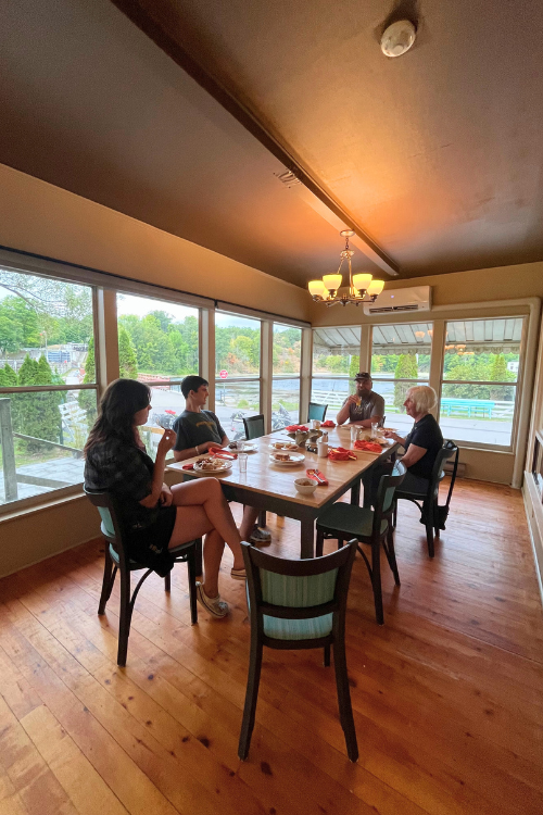 Dining on the covered veranda at Hotel Kenney, a family enjoys Sunday brunch with views of the Rideau Canal.