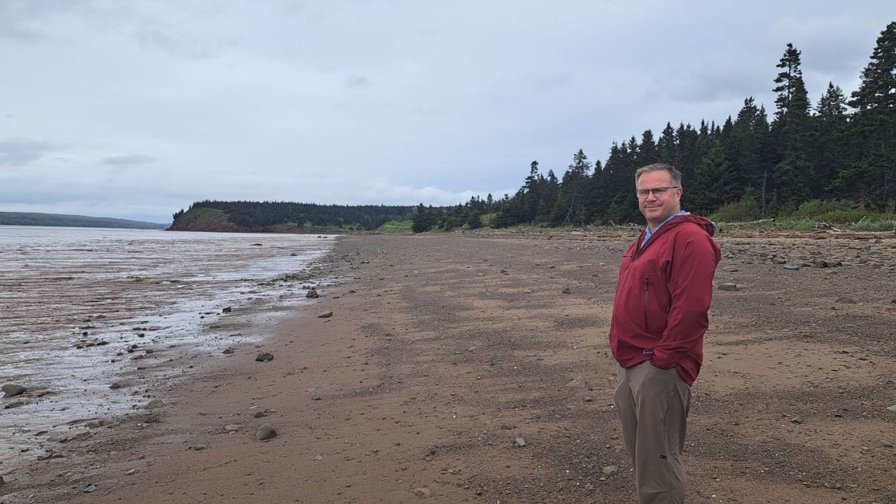 A man walks on the beach at Johnson's Mills Shorebird Reserve and Nature Sanctuary near Dorchester NB. 1/4 of a million sandpiper birds flock here every summer.