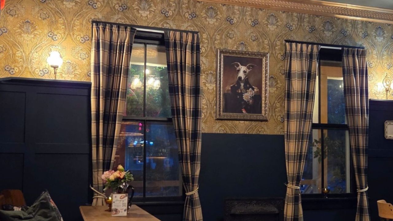 A framed picture of a whippet dressed in regal clothing adorns the wall in the cozy little English Pub called the Thirsty Whippet at Ladysmith Manor in Dorchester New Brunswick