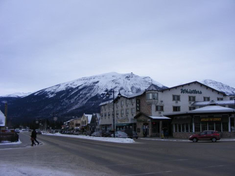 Jasper townsite glimmers under a fresh layer of snow as VIA Rail’s The Canadian pauses in the Rockies, offering winter travellers a peaceful glimpse of small-town alpine charm during a transcontinental journey.