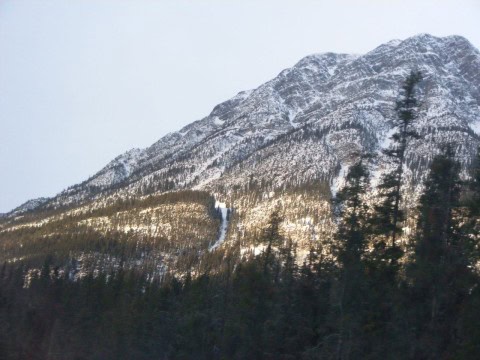 VIA Rail’s The Canadian passes through the snow-covered Rocky Mountains, revealing dramatic peaks, frozen valleys, and serene alpine vistas — a highlight of Canada’s winter landscapes on a cross-country train journey.