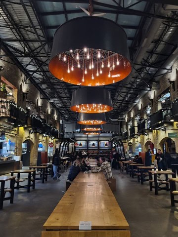 Inside Winnipeg’s Forks Market, warm lights, local vendors, and seasonal décor offer a welcoming contrast to the winter cold during a pause on VIA Rail’s The Canadian cross-country train journey.