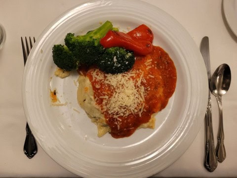Dinner aboard VIA Rail’s The Canadian on day one features freshly prepared meals served in the dining car, combining comfort, conversation, and classic rail travel as winter landscapes pass beyond the windows.