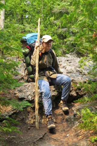 Eh Canada Adventure Seeker Sonya Richmond backpacking the Bruce Trail along Ontario’s Niagara Escarpment carrying a large backpack, illustrating long-distance trekking across forests, limestone cliffs, and rugged landscapes between Queenston Heights and Tobermory.