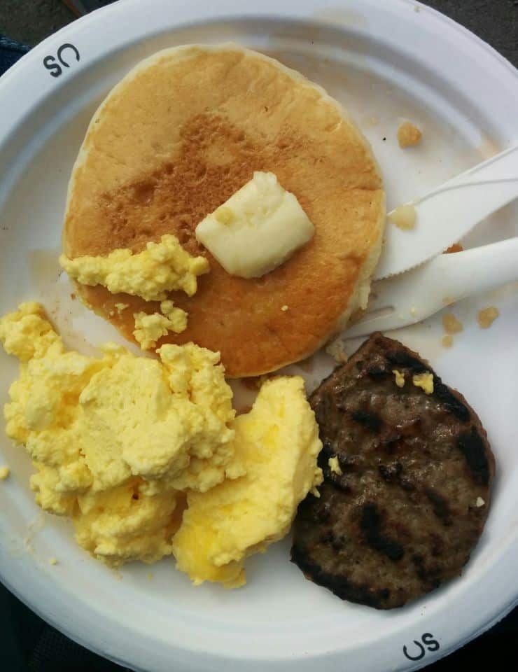 Pancake breakfast plate with eggs and sausage at a Calgary Stampede community breakfast in Alberta Canada