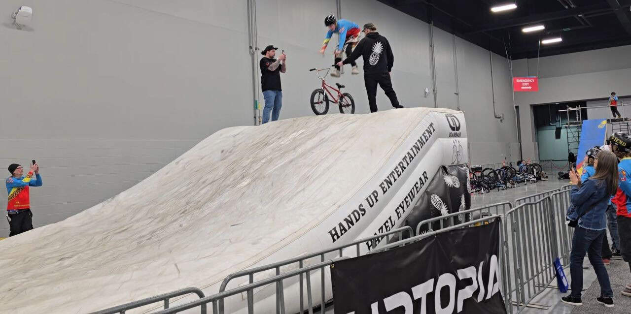 Cyclist performing a jump at the Alberta Bike Show during the Calgary Outdoor Adventure & Travel Show at the BMO Centre in Calgary, Alberta.