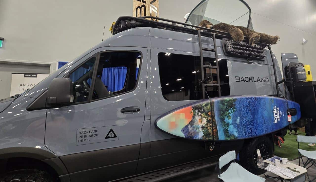 Backland Expedition Gear van display at the Calgary Outdoor Adventure & Travel Show in Calgary, Alberta, showcasing an overland vehicle built for off-grid travel and outdoor adventures.