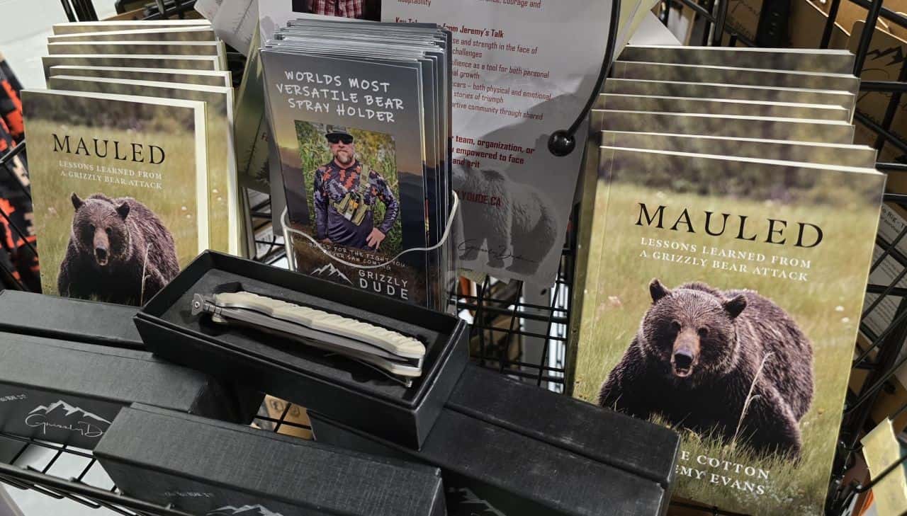 Jeremy Evans Grizzly Dude display at the Calgary Outdoor Adventure & Travel Show in Calgary, Alberta, featuring his book and bear safety equipment for outdoor awareness.