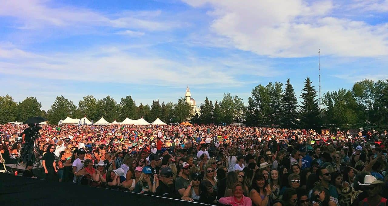 large crowd at outdoor summer music festival in Alberta or Saskatchewan during daytime