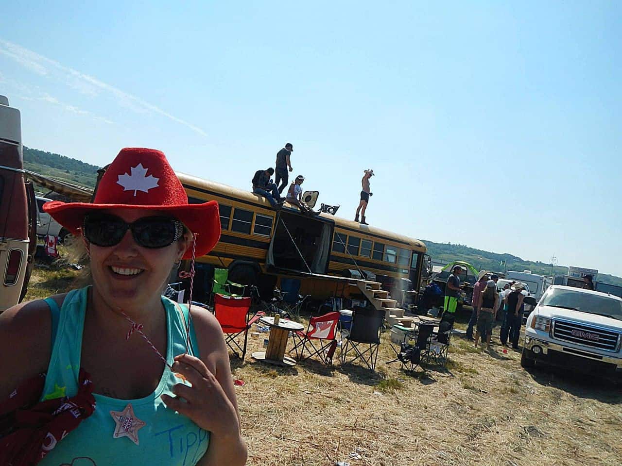 festival campground in Saskatchewan with converted bus and campers at country music festival