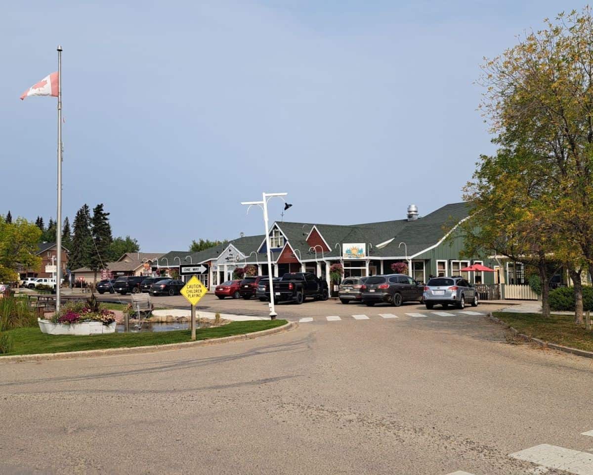 Street view of shops at The Village at Pigeon Lake in Alberta with cafés and local businesses along the road cycling route