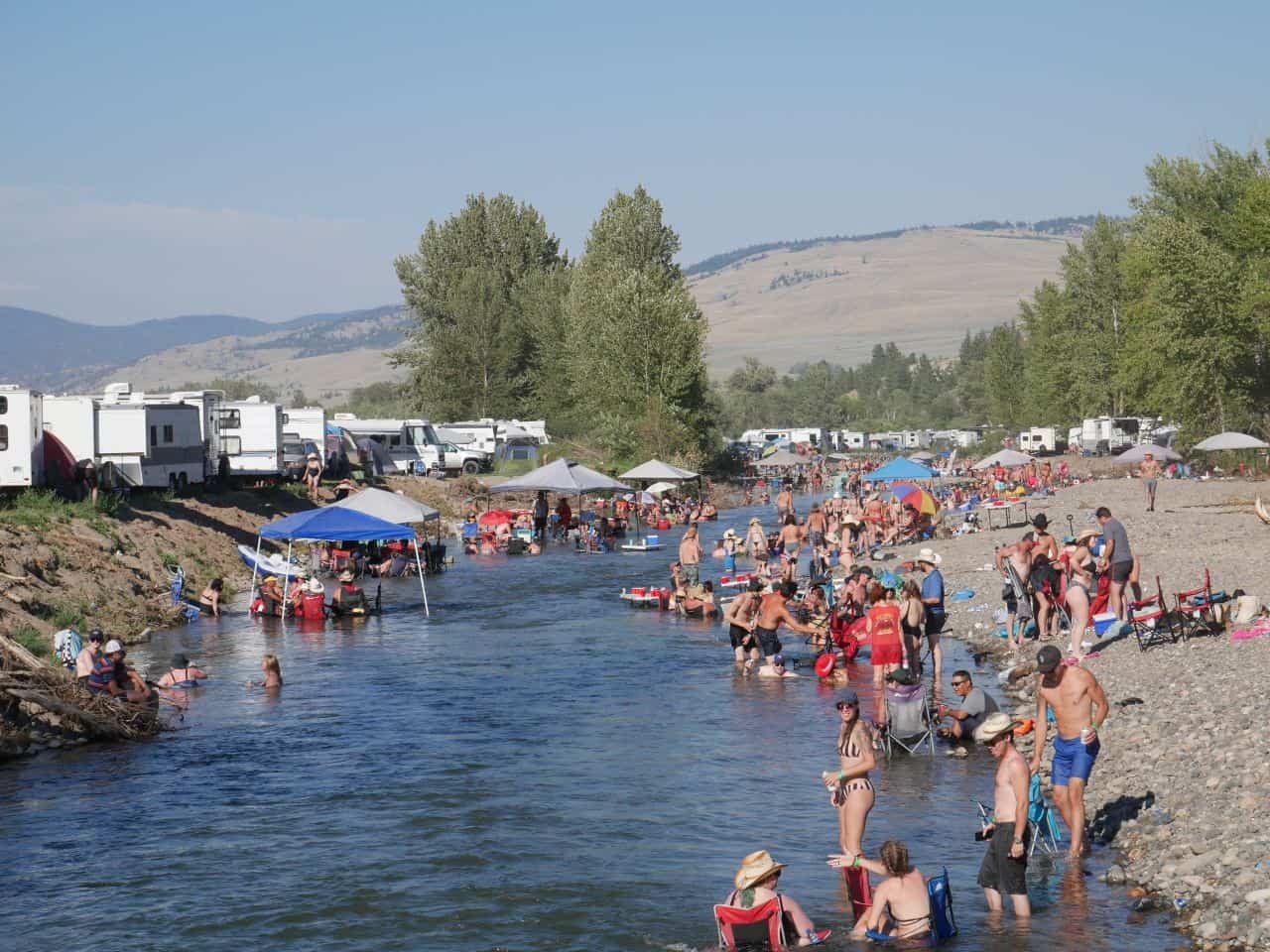 Festival goers celebrate country music in the sunshine in Merritt BC's most famous river.