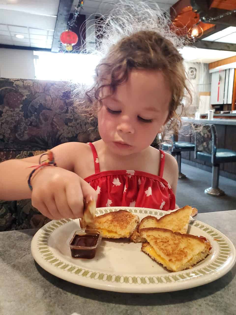 Grilled Cheese and Maple Syrup  - Such a little Canadian...grilled cheese with maple syrup and her maple leaf bathing suit!