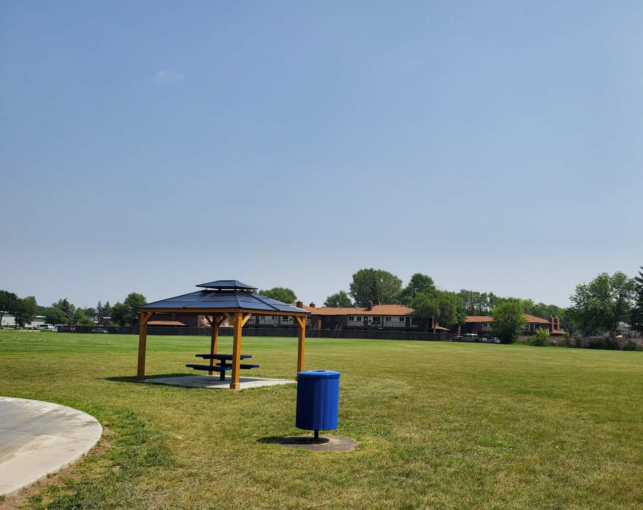 Regal Heights Park Playground Splash Pad in Moose Jaw Saskatchewan Canada 2024-07-16 - A few covered picnic tables are available at Regal Heights Park. You may want to bring your own umbrella for the shade as these picnic tables are scooped up quickly 