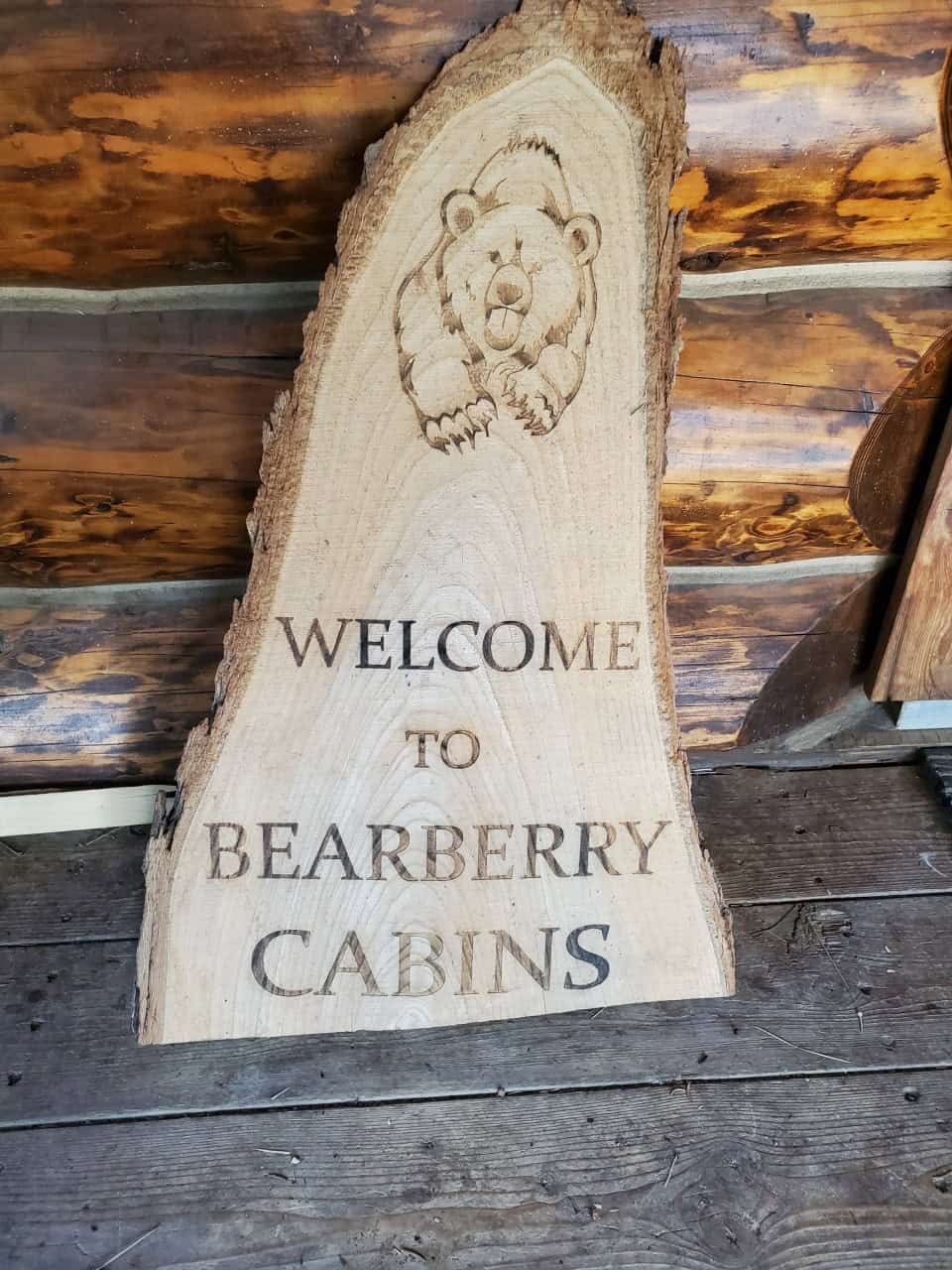 Welcome Sign at Bearberry Cabins Check In Office - Cute litte wood sign on the porch at Bearberry Cabins. You check in at the office to the left of the cabins