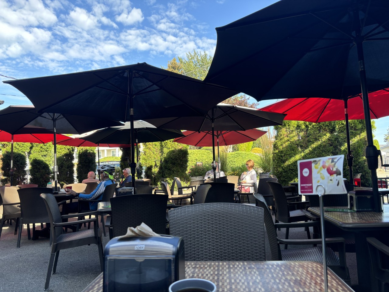 Outdoor dining at The Bench Market in Penticton BC 2024-09-24 - It was mid morning when I stopped for breakfast at The Bench Market. So nice to sit under the umbrella shade on the patio.