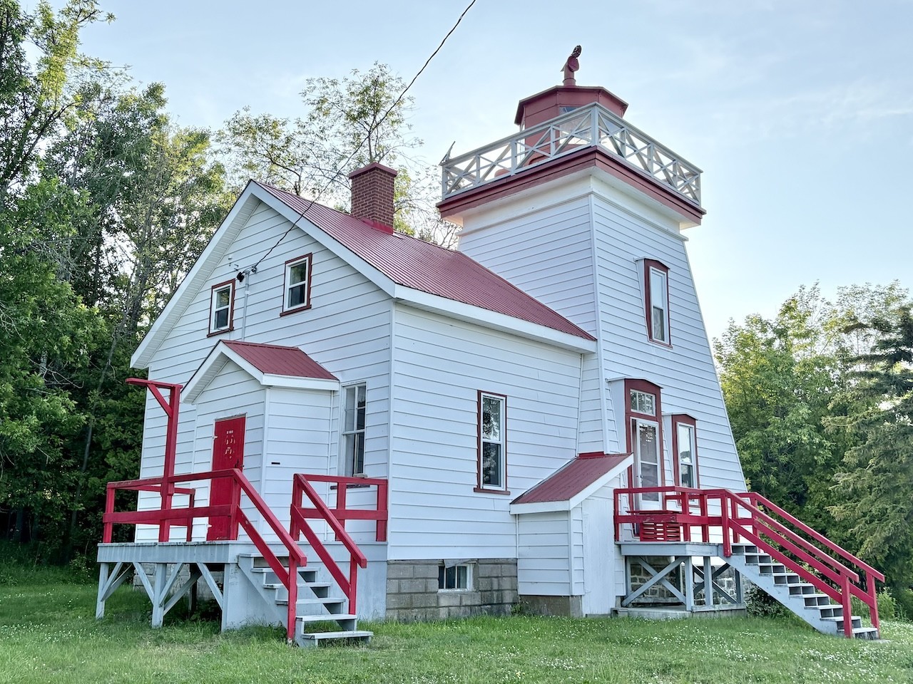 Janet-Head-Lighthouse-Manitoulin-Ontario - The classic read and white design stands as a beacon of the past. Ships were guided safely through the North Channel by the light of Janet Head Lighthouse in Manitoulin Island, Ontario, Canada. 